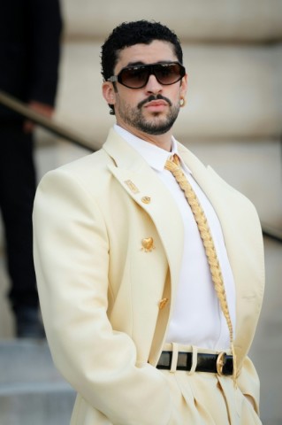 Bad Bunny in yellow with a gold tie