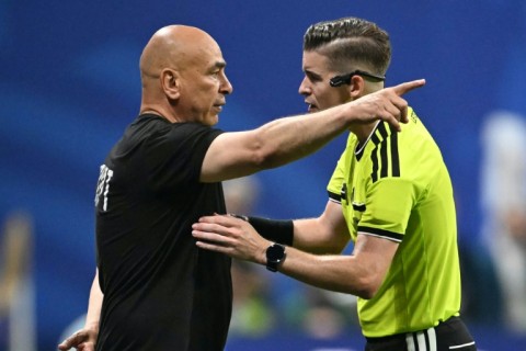 Egypt's head coach Hossam Hassan remonstrates with French referee Francois Letexier during his team's stormy 3-2 defeat to Argentina