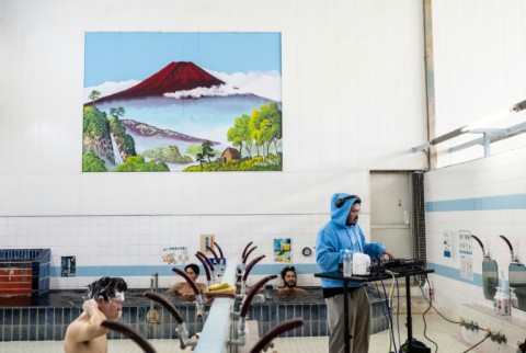 Bathhouse owner Katsuhito Okubo was wary of hosting the group at first but said he "felt they were really trying to understand our living space" 