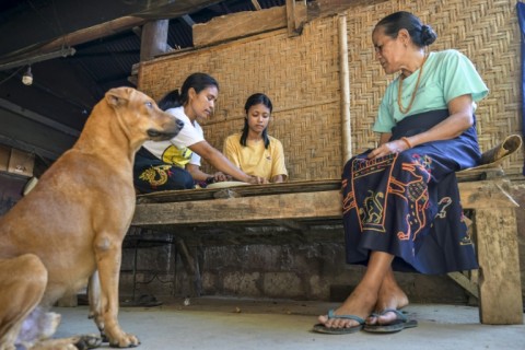 Noblewoman Tamu Rambu Margaretha (right), who has spoken up for ata emancipation, watches as two of her slaves prepare a meal