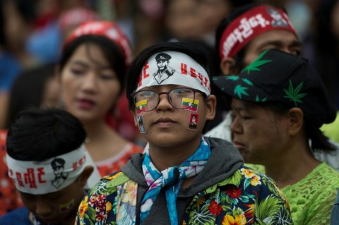 People wearing head bands with the portrait of General Aung San arrive to pay their respect before the Martyr's Mausoleum in Yangon in July 2018