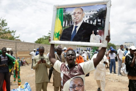 Supporters of former Senegalese president Macky Sall gather outside the airport ahead of his arrival in Dakar on July 17, 2026