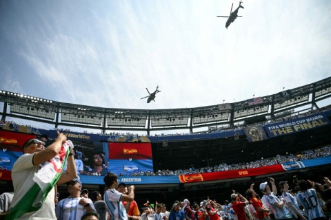 Two US Marine Corps aircraft, with one of the helicopters believed to be carrying U.S. President Trump, fly above the stadium ahead of the 2026 World Cup football tournament final match between Spain and Argentina at the New York/New Jersey Stadium in East Rutherford on July 19, 2026.