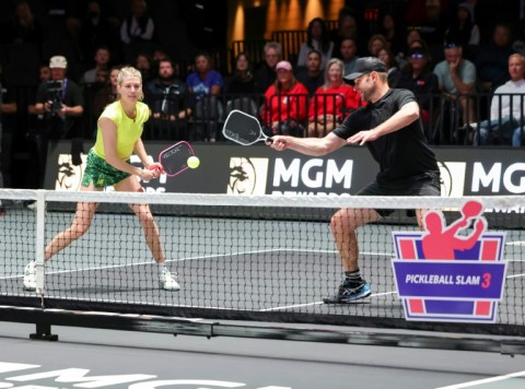 Andy Roddick (R), a retired American tennis player who has a role in the new comedy film "The Dink" about friends who play pickleball, competes in a 2025 pickleball tournament with Canadian tennis veteran Eugenie Bouchard