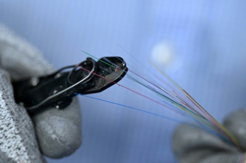 Technicians work around the clock to turn glass into hair-thin fibre-optic strands destined for data centres