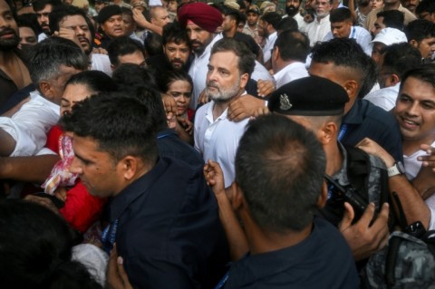 Security personnel detain Indian opposition leader Rahul Gandhi (C) during a protest outside Prime Minister Narendra Modi's residence in New Delhi on Tuesday