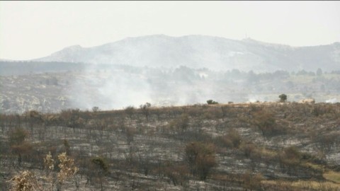Smoke rises from burnt landscape as Spain wildfire rages