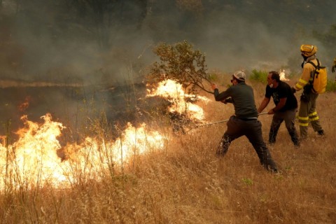 Some local residents have pitched in to help Spanish firefighters tackle the flames
