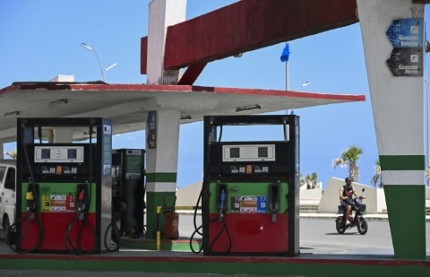 A man rides past an empty gas station in Havana