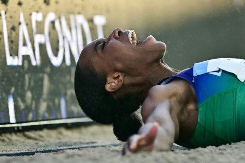 Dominica's Thea LaFond celebrates winning the women's triple jump