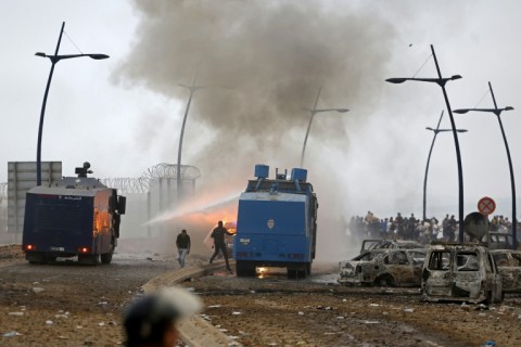 Moroccan security forces use water canon to disperse the crowds at the site of clashes near Fnideq on the Morocco-Spain border