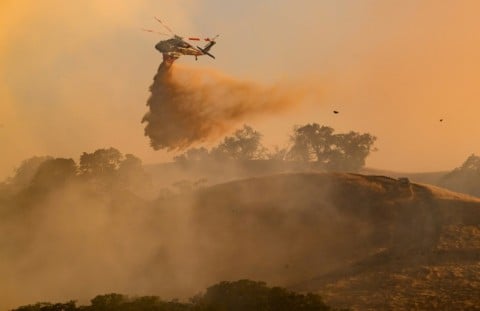 A helicopter drops water on Little Fire in Pleasanton, California on July 21, 2026