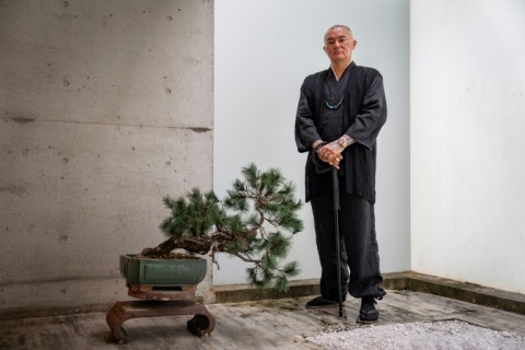 Tattoo artist Remy posing at his studio in Ginowan