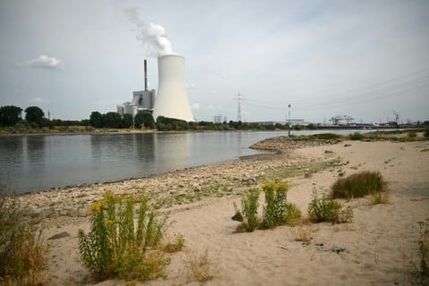 The partially dried-up river bed of the Rhine near a power station in Duisburg