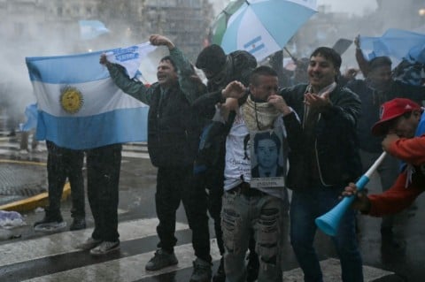Demonstrators braved rough weather to demand changes to property laws being considered by the Senate, gathering outside the National Congress in Buenos Aires