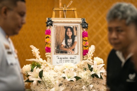 A portrait of a 12-year-old school shooting victim is displayed in front of the coffin during her funeral at the Wat Lat Pla Duk Buddhist temple in Thailand.