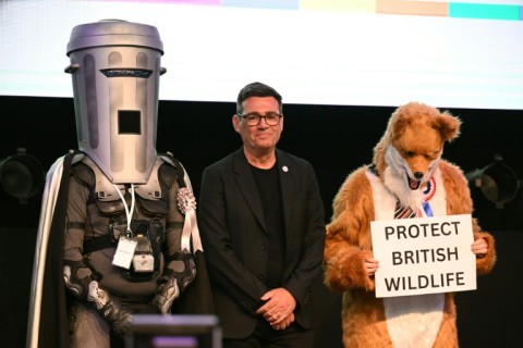 Count Binface stands next to Labour's Andy Burnham and a Protect British Wildlife candidate after the Makerfield by-election in June