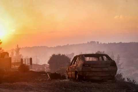 A burnt car is seen after a wildfire near the village of Siviri, northern Greece