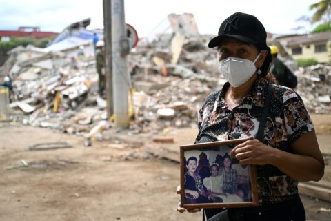 Marlene Nino lost her sister in Monday's earthquake, but was able to recover some family photos