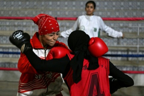 Professional boxer Aliya Soomro watches junior boxers during a sparring session