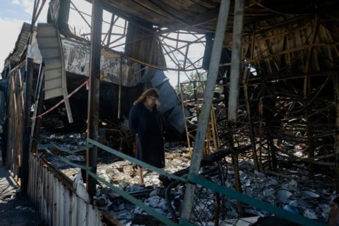 Shards of glass and porcelain crunch under feet as traders walk through the remains of their stalls