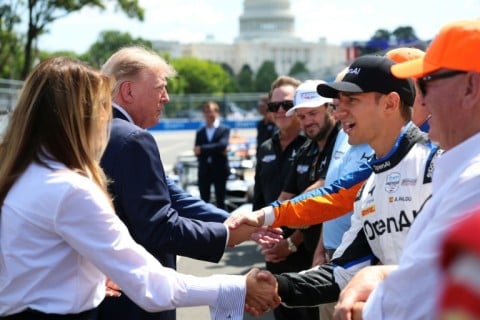 US President Donald Trump and First Lady Melania Trump, at left, greet IndyCar drivers before the start of the Freedom 250 Grand Prix on the streets of Washington