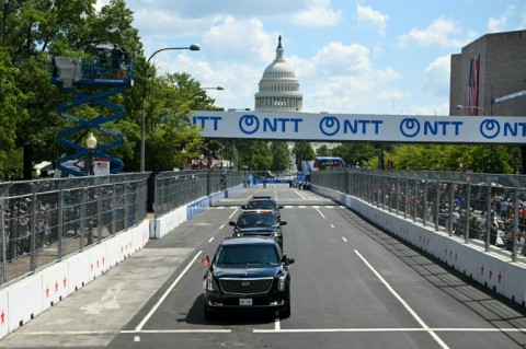 US President Donald Trump rides in the presidential limousine, known as "The Beast," on the track prior to the start of the IndyCar Freedom 250 Grand Prix in Washington