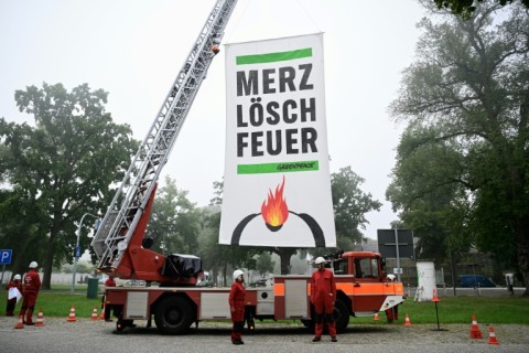 Greenpeace activists near the cabinet retreat set up a fire engine with a banner demanding: 'Merz, extinguish the fire'