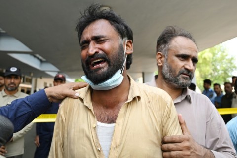 A man in tears outside the PIMS maternity ward, where a fire killed more than a dozen infants