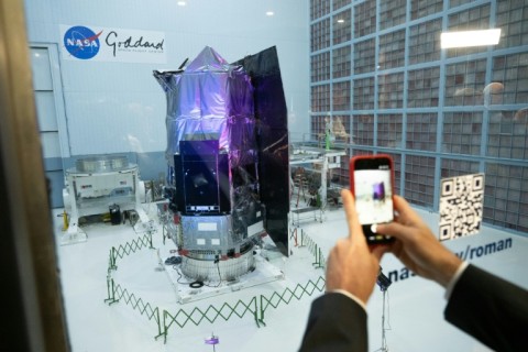 A journalist photographing the Nancy Grace Roman Space Telescope at NASA's Goddard Space Center in Greenbelt, Maryland in April 2026