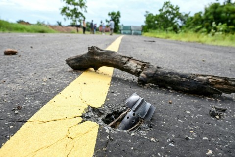 An unexploded 80mm mortar on a road in Cambodia's Chouk Chey village, months after deadly border clashes with Thailand
