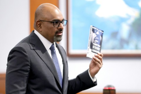 Prosecutor Binu Palal holds a copy of the book 'Compton Street Legend' during closing arguments in the trial of Duane Davis for the 1996 killing of rapper Tupac Shakur