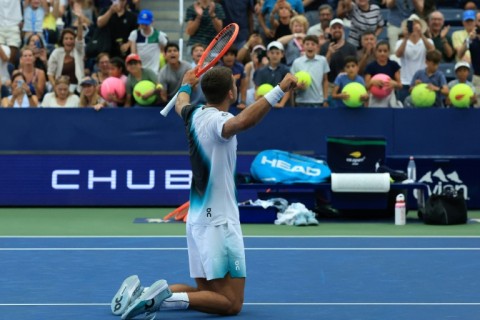 Italy's Flavio Cobolli celebrates after beating Argentina's Francisco Comesana in five sets