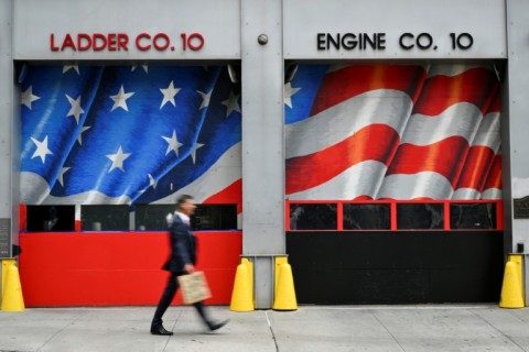 A man walks past a New York City fire station near 'Ground Zero,' where the World Trade Center once stood