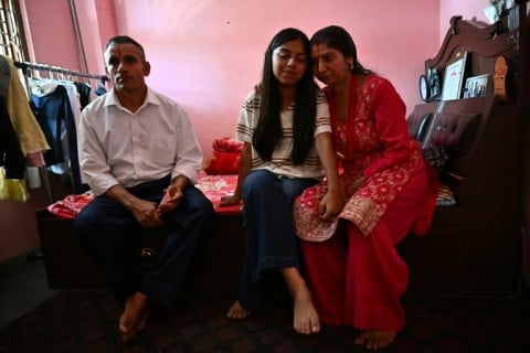 Twisting her phone in her hands, Santoshi broke down into tears as she recalled the anguish of not knowing for hours whether her parents had survived