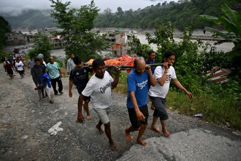 Mourners carry a body during a funeral ceremony in Nepal's Nuwakot district on Monday