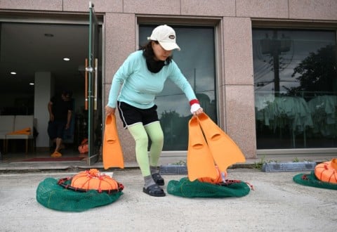 South Korean haenyeo Choi Young-hee, who runs an organisation teaching haenyeo culture and training aspiring divers, preparing for a haenyeo training session in the South Korean coastal town of Geoje