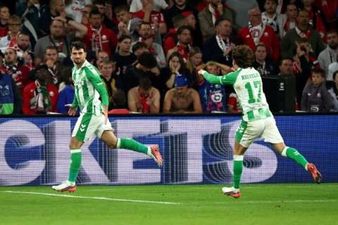 Troy Parrott celebrates after scoring the winning goal for Real Betis away to Lille in France