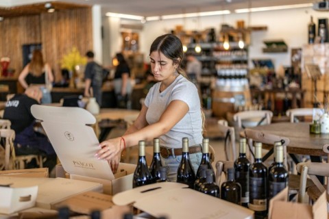 A worker boxes wine bottles at a winery facility in the Israeli settlement of Shaar Binyamin