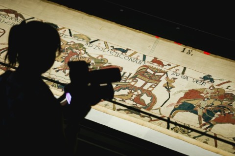 A camera operator videos a section of the Bayeux Tapestry during the press preview at the British Museum in London