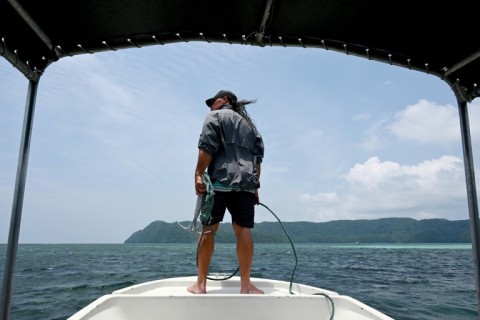 Biologist Ron Leidich prepares to deploy an anchor near potential monitoring sites at Ngederrak Reef off the coast of Koror, Palau, where dugong herds feed on seagrass beds