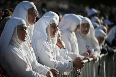 Nuns wait for the start of Sunday mass in Lourdes
