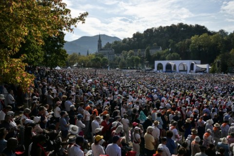 Worshippers packed a field in Lourdes