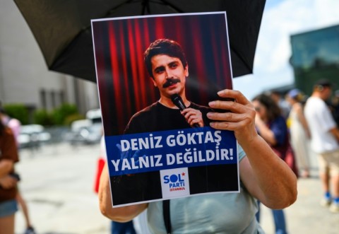 Protesters carried signs saying 'Deniz Goktas is not alone!'