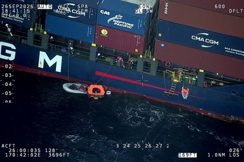 A 143-metre (470-foot) container ship rescued four sailors after their yacht collided with a sperm whale