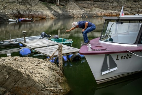 Yvan Durig measuring the water level in what remains of the Lac des Brenets, part of the Doubs river