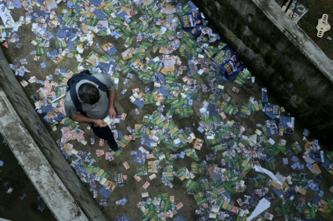 Election campaign leaflets litter the ground in Rocinha, Brazil