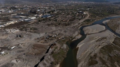 Machines work amid the huge waste dumps of Albania's Elbasan steelworks