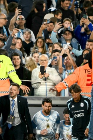 Lionel Messi enters the to warm-up ahead of his final international for Argentina