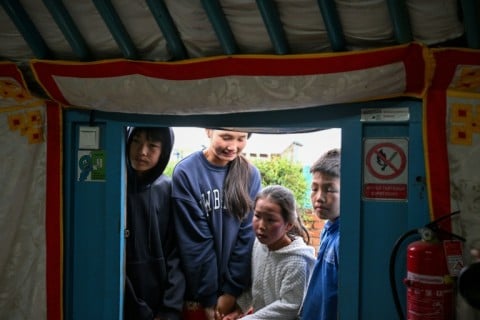 Children arrive to have their teeth checked at a mobile dental clinic inside a traditional Mongolian ger in Ulaanbaatar
